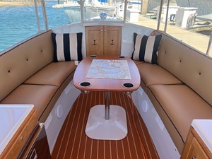 2022 Duffy 22 Cuddy Cabin 6 Port and starboard sits with cushion; Large teak table with four drink holders