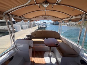 2022 Duffy 22 Cuddy Cabin 14 Helm station and movable teak table with drink holders.