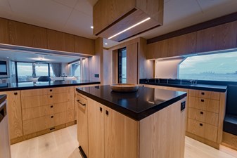 Horizon FD100  12 Large galley island with black countertops. 
