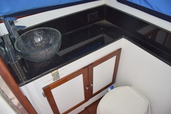 RAMPAGE 27 Head with granite vanity, backsplash, and basin sink