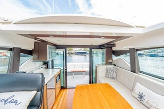 IT'S FOR YOU TOO 10 Skylite view of Salon - Dinette Lounge - Galley - Helm