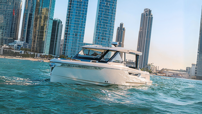 ICE 2 Front view of Saxdor 400 GTO ICE yacht cruising in Dubai waters with city skyline in background.