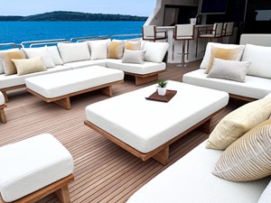 Horizon FD90 7 Horizon FD90 Hull 34 Split-use large boat deck with loose loungers and coffee tables and yellow pillows.
