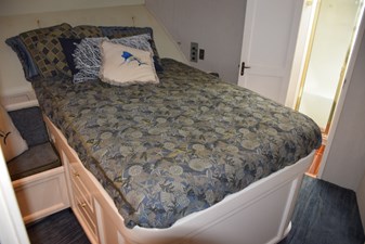 LOW BIDDER X  14 Walkaround queen berth with changing seats on either side of berth  