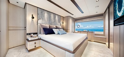 Horizon FD90  5 Large master stateroom with stone headboard. 