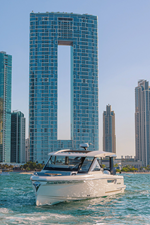 ICE 3 Front view of Saxdor 400 GTO ICE yacht cruising in Dubai waters with city skyline in background.