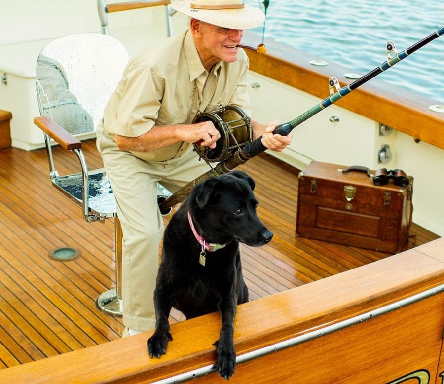 An image of a man and his dog fishing with a fighting chair