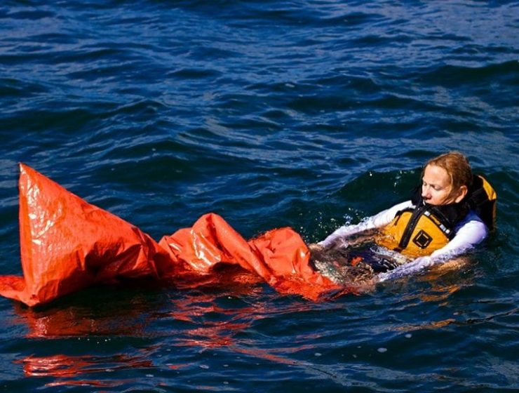 An image of a woman using the Land Shark Survival Bag