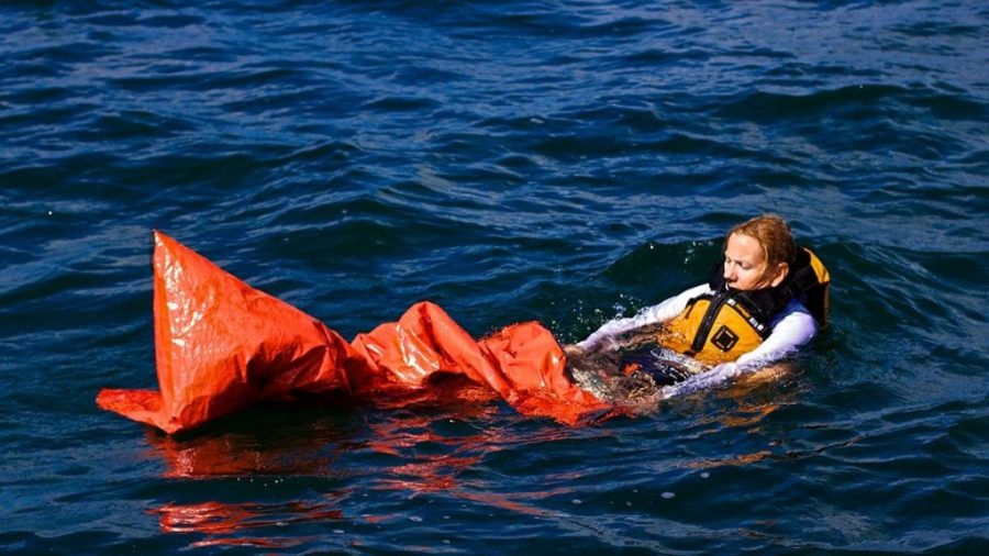An image of a woman using the Land Shark Survival Bag