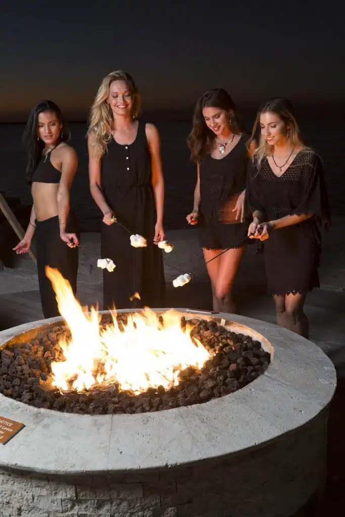 Four models roast marshmallows at the Playa Largo Resort and Spa