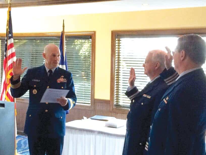 This is an image of Thomas M. Stokes, Sr. (middle) being sworn in as the new division commander.