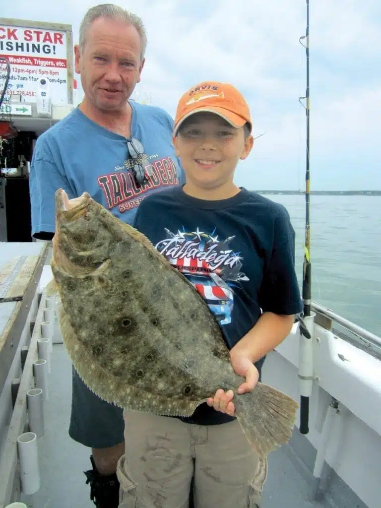 an image of a father and son fishing fluke
