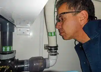 Man Sniffing Sanitation system pipe