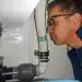 Man Sniffing Sanitation system pipe