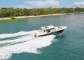The Scout 377 lxf crossing along blue-green waters