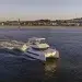 The Leopard 40 Powercat cruising across deep blue waters with a ocean town in the background