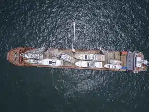 Overhead photo of multiple yachts being transported on a container vessel in transit