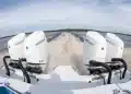 Close-up image of Four Mercury Marine Verado V10 Outboards in operations across a lake.