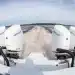 Close-up image of Four Mercury Marine Verado V10 Outboards in operations across a lake.
