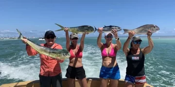 Four women holding up their championship winning catches