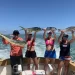 Four women holding up their championship winning catches