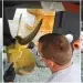 Man cleans and paints boat bottom