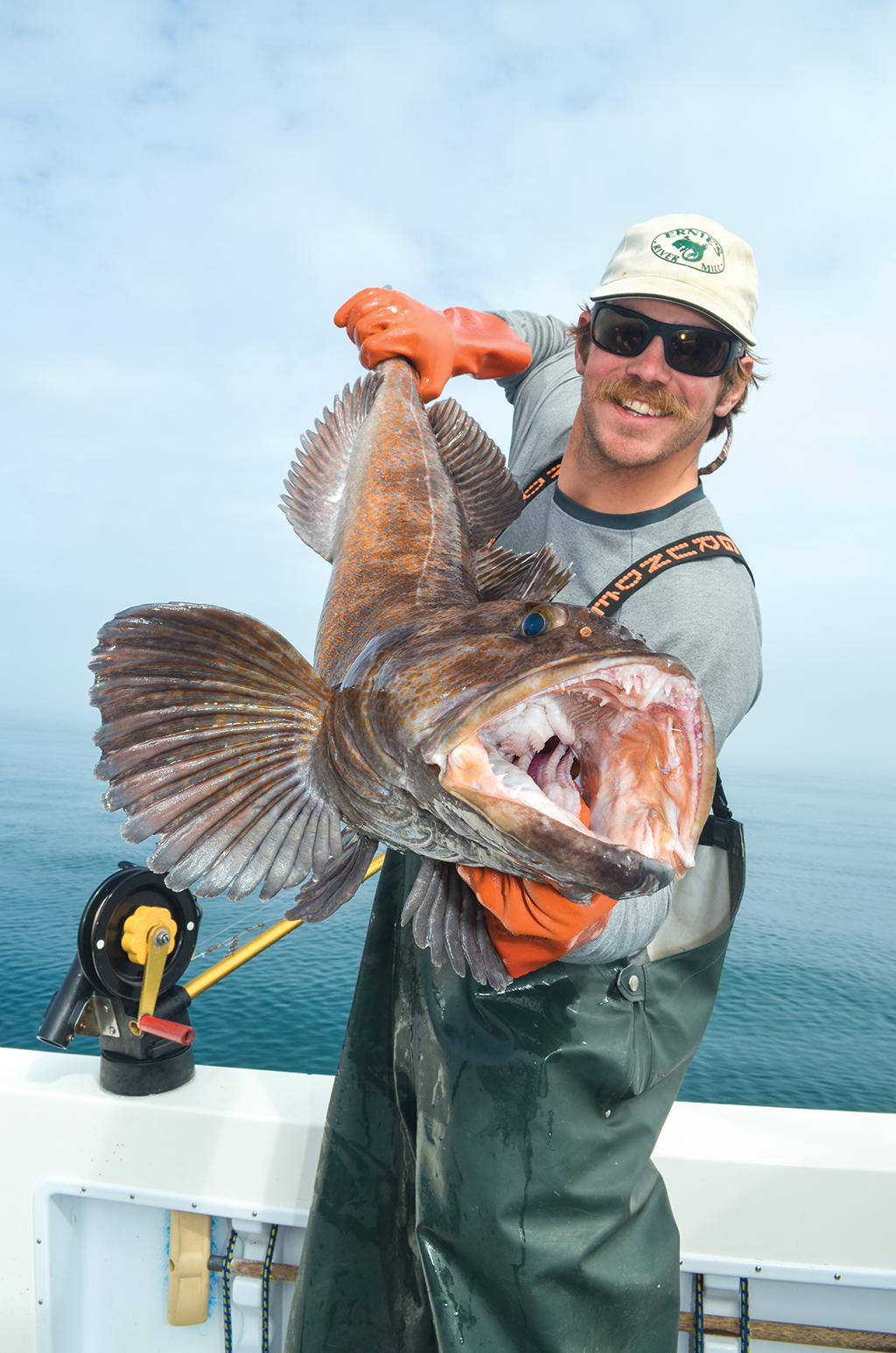 A man holds a fish showing an example of the perfect fishing photo