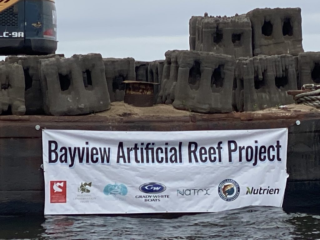 A view of the Bayview Artificial Reef Banner with equipment stacked behind it.