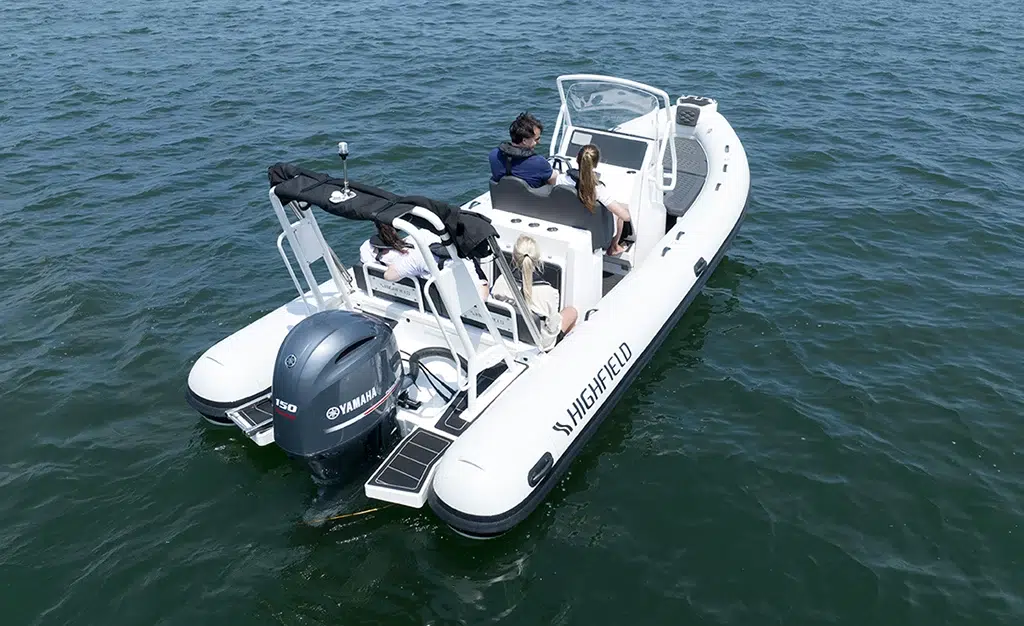 A group of four people enjoying a moment floating on water in their Highfield RIB