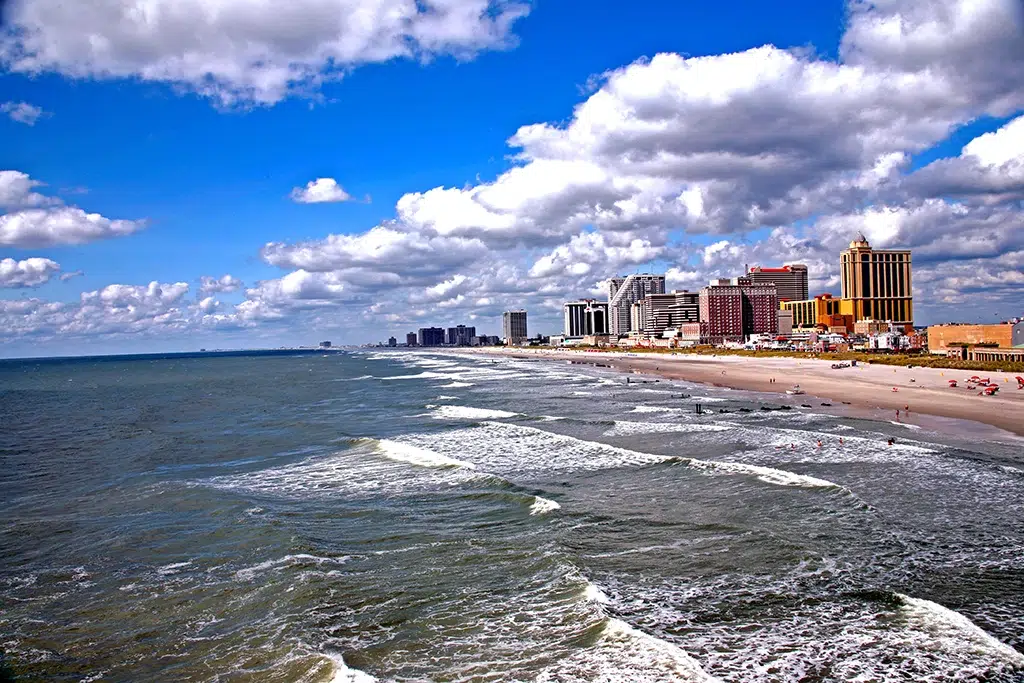Atlantic City provides a backdrop to small waves crashing on their shore.