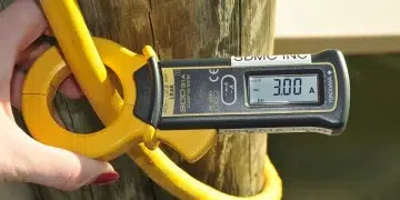 A person measuring Amps with a device on shore