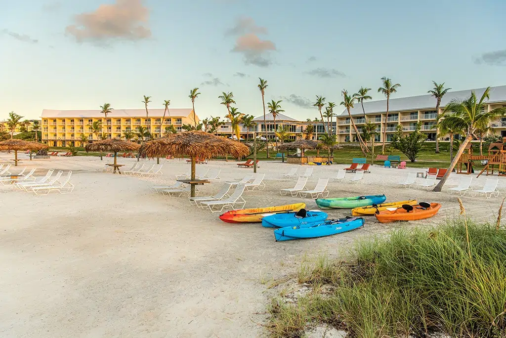The beachside of the resort with paddle boards in the sand