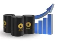 Oil barrels in front of a graph showing increases