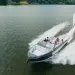 A stern-side view of the Aviara AV28 slicing across still lake waters