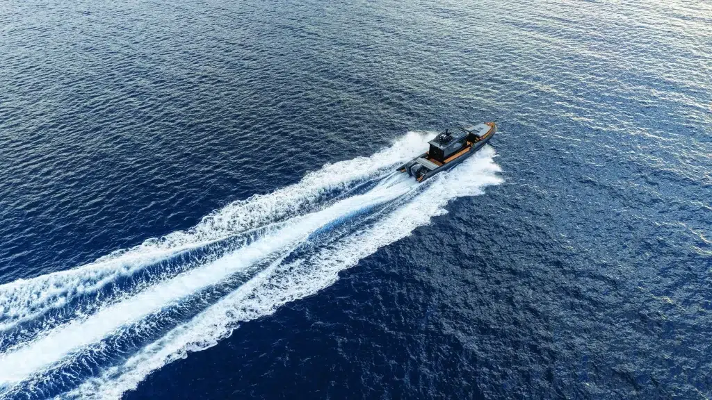 A Boat using COX Marine Diesel Outboards crosses deep blue waters