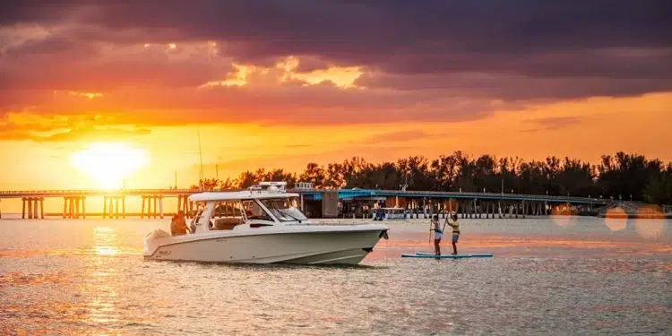 Boston Whaler 350 Realm with a sun setting in the background