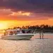 Boston Whaler 350 Realm with a sun setting in the background
