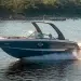 Chaparral SSX 267 slicing across deep blue waters with a treeline in the background