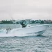 A side profile view of the EdgeWater 340cc gliding across water