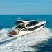A rear quarter view of Galeon Yachts slicing through larger swells
