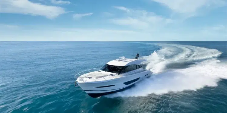 The Maritimo yacht cutting across blue-green waters with a nearly clear blue sky
