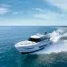 The Maritimo yacht cutting across blue-green waters with a nearly clear blue sky
