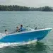 The Sailfish 226DC cutting across water with a family onboard