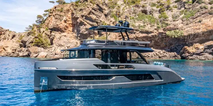 Explorer Yachts 62 in clear water with a rocky background