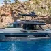 Explorer Yachts 62 in clear water with a rocky background