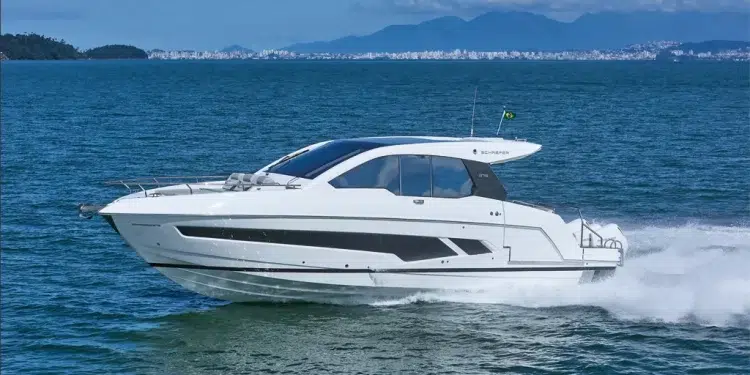 The Schaefer 375 jetting across blue waters with mountains in the background