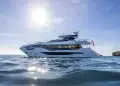 A side profile view of the Sunseeker 100 Yacht with reflective water in the foreground.