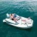A three person family sititng on a Walker Bay Generation 12 floating on still waters