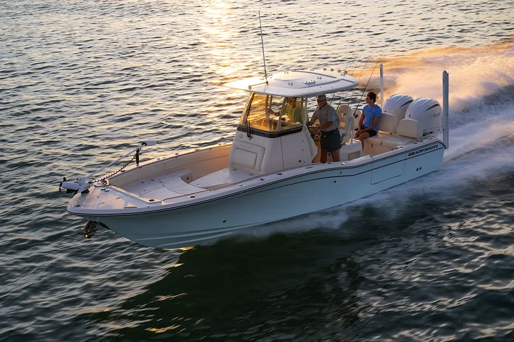 A Grady White 281 CE running at sunrise as the light reflects on the water behind the boat