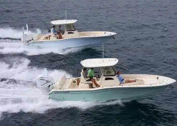 Two Grady White 281 CEs running across water from left to right at near eye-level